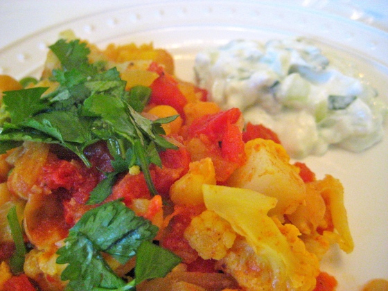 Garnish with cilantro and serve with raita.